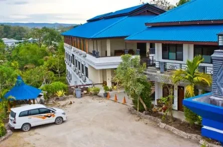 Sinar Tambolaka Hotel building with blue roofs