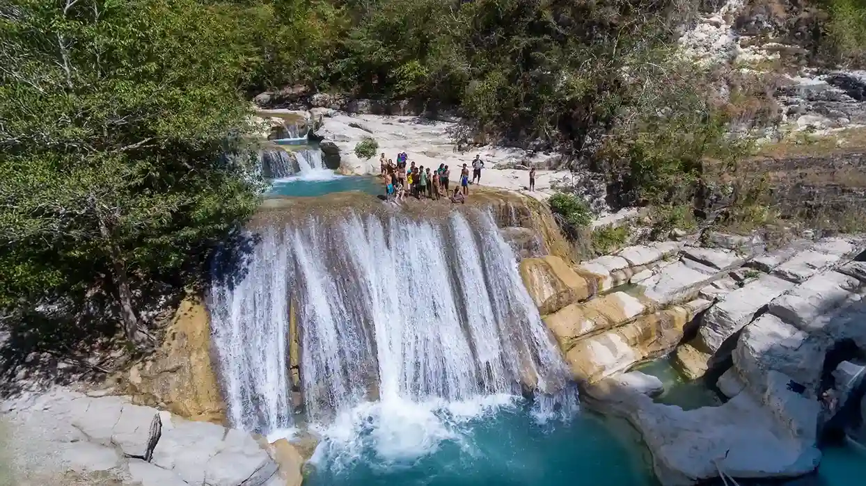 Tanggedu Waterfall pouring into a turquoise pool