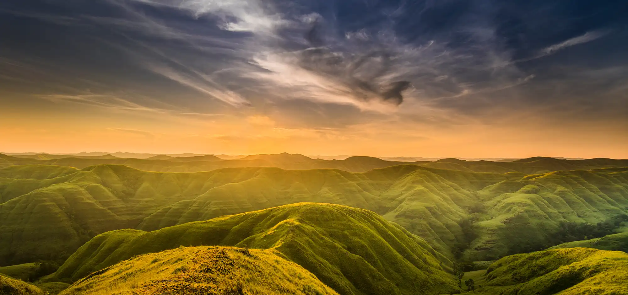 Sunset over the green hills of Warinding